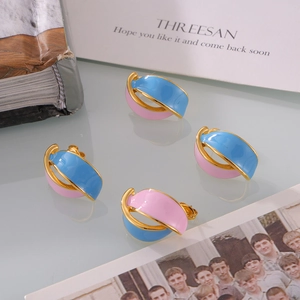 Vintage enamel leaf earrings in pink and blue contrast with golden twisted semi-circle