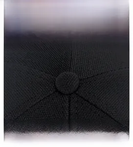 Detailed macro view of black baseball cap crown showing mesh texture and stitched seams