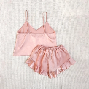 Women's silk satin pajama set with V-neck camisole and ruffled shorts in dusty pink