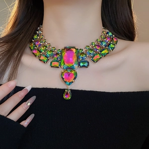 Macro shot of colorful geometric crystal necklace with square and heart pendant detail