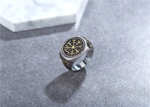 Close-up of Viking compass ring with golden Vegvísir totem on silver steel band