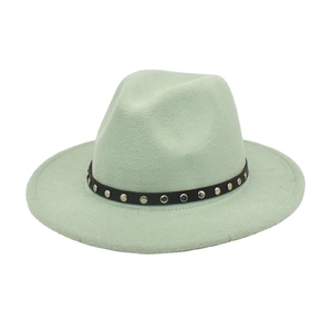 Detail of mint green fedora hat featuring a black faux leather band with silver metal studs