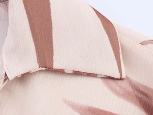 Close-up of V-neck collar and high-quality floral chiffon fabric with striped texture
