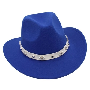Detail of royal blue fedora hat featuring white leather band with pearls and metal studs