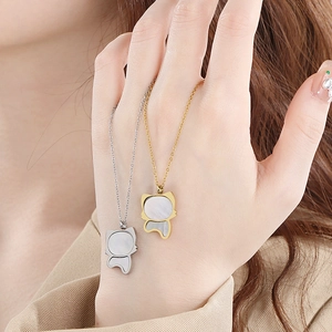 Close-up of cat-shaped mother of pearl pendants in gold and silver steel