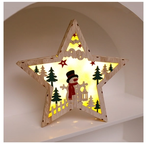 Detail of wooden star Christmas lamp with LED snowman and tree carvings in a white niche