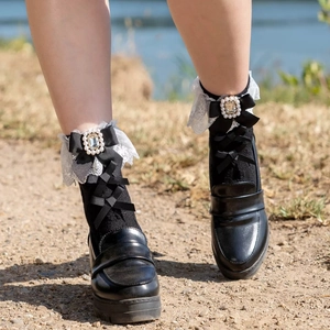Cute black Lolita ankle socks with white lace trim, black bow, and rhinestone pearl accents