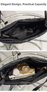 Internal capacity of quilted black shoulder bag showing smartphone and makeup items