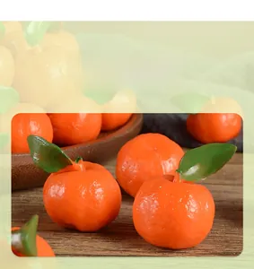 Macro shot of realistic PVC mini oranges with green leaves and detailed skin texture