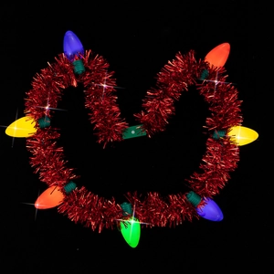 Close-up of heart-shaped red tinsel necklace with colorful glowing LED bulbs