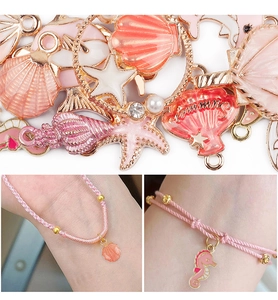 Detailed view of pink sea shell and seahorse pendants on DIY alloy charm bracelets