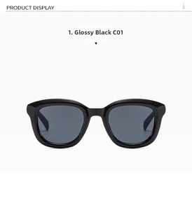 Close-up of classic round frame sunglasses in bright black finish with dark grey lenses