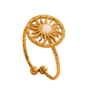 Adjustable gold sunflower ring featuring a white opal stone inlay with hammered texture