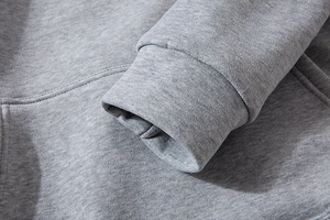 Close-up of grey zip-up hoodie featuring ribbed cuffs and textured knit fabric detail