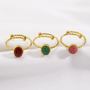 Three-piece set of gold 14K hammered rings with colorful gemstones and open bands