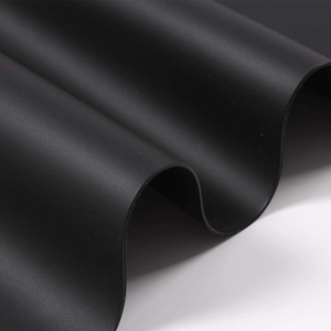 Matte black heat resistant large silicone desk mat showing flexible wave texture