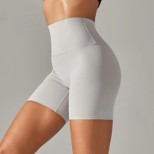 Detail view of high-waisted gray yoga shorts showing elastic fabric and shaping effect