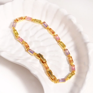 Elegant 18K gold-plated bracelet featuring colorful square zirconia on a white shell tray