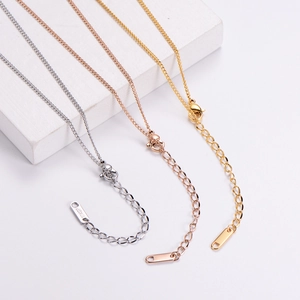 Detail of adjustable extension chain and lobster clasp on 18KGP metal necklaces