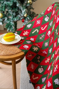 Detailed view of woven jacquard Christmas fabric featuring Santa and nutcracker motifs