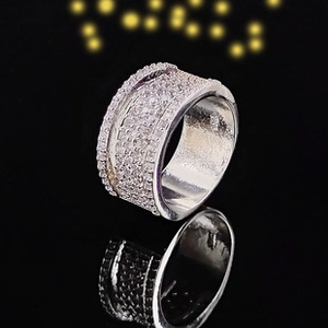Macro shot of wide multi-row silver band ring with pavé synthetic zircon stones