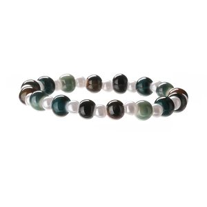 Close-up of creative colorful ceramic shell beads and pearls bracelet on white background