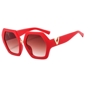 Fashionable red hexagonal sunglasses with gradient lenses and gold V-shaped metal logo