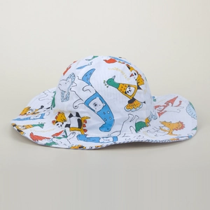 Detailed close-up of cartoon animal prints on white cotton kids bucket sun hat