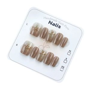Handmade cat-eye press-on nails with bamboo leaf pattern and milk coffee gradient effect