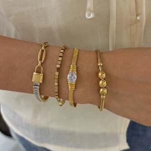 Four-piece gold stainless steel bracelet set with zircon stones on a female wrist