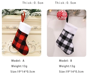 Detail view of red and black buffalo plaid Christmas stockings with plush white cuffs