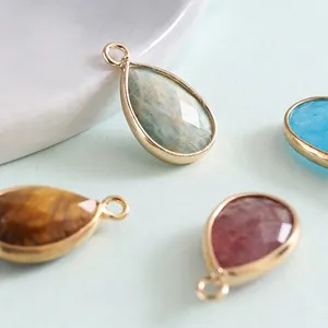 Water drop shaped natural stone pendants with multi-faceted cut and metal frame inlay