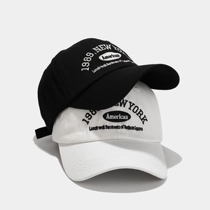 Close-up of 1989 New York embroidery detail on premium black and white cotton baseball caps