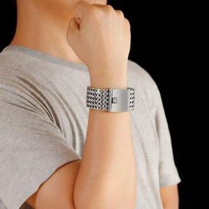 Macro shot of men's chunky stainless steel chain bracelet with interlocking link texture