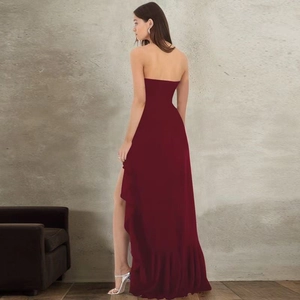 Detail view of burgundy strapless gown with ruffled hem and sexy side high slit