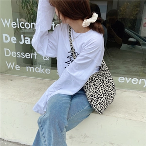 Stylish large capacity leopard print canvas tote bag paired with casual street style outfit