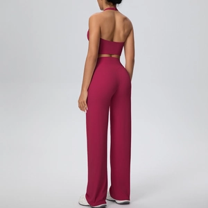 Back view of pink halter sports top and high-waisted wide-leg yoga pants set
