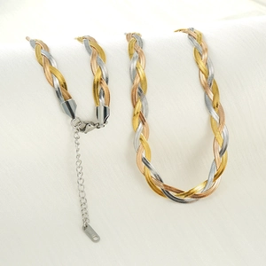 Detailed view of handmade woven titanium steel necklace and bracelet set in three tones