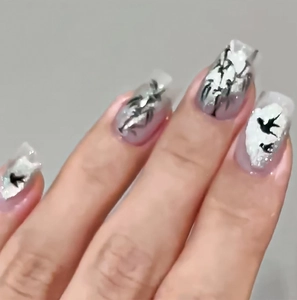 Detail showing 3D embossed texture and black swallow patterns on long square press-on nails