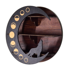 Macro detail of crescent moon wood shelf featuring wolf silhouette and golden moon phases