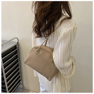 Minimalist beige PU leather tote bag shown on shoulder for daily commute style