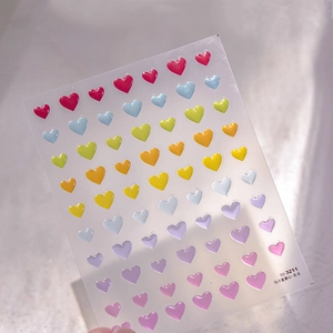 Macro view of 3D macaron heart nail stickers with colorful resin embossed texture