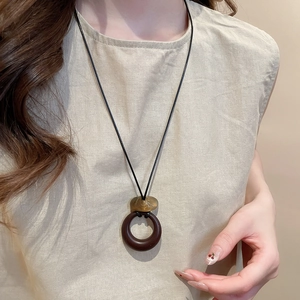 Close-up of resin round pendant necklace on model with vintage bohemian style
