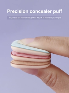 Close-up of mini colorful finger puffs for concealer in pink, blue, and nude shades
