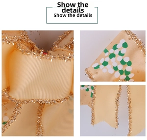 Detail of yellow Christmas ribbon bow with gold glitter edges and green polka dots