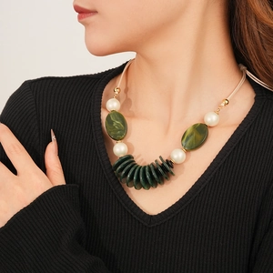 Detail of vintage double-layer leather necklace with green oval resin and pearls