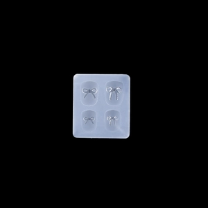 Detailed macro view of 4-cavity bow-knot silicone mold for 3D nail art and DIY resin crafts