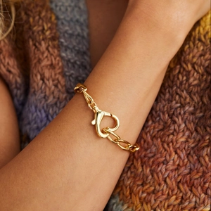 Minimalist gold heart lock pendant necklace featuring a large heart lobster clasp closure
