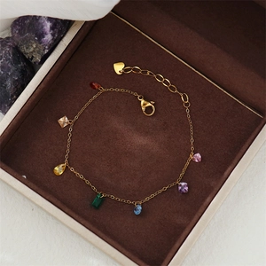 Detail of 18K gold plated bracelet with colorful rainbow zircon charms in jewelry box