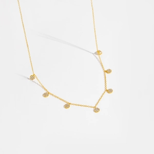 Close-up of a gold S925 sterling silver necklace with seven sparkling zircon circle charms